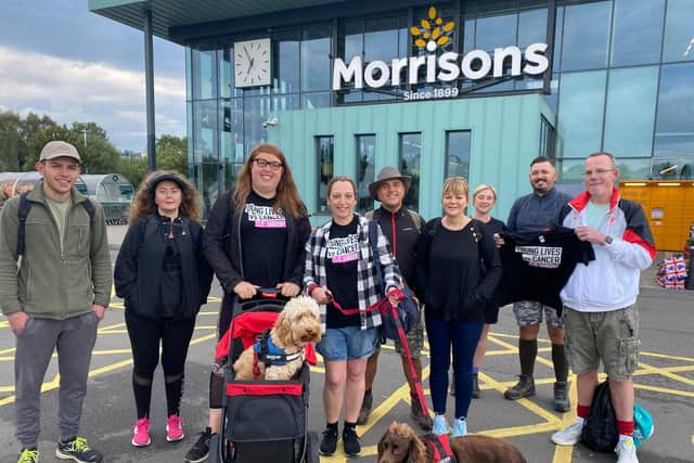 A team from Morrisons in Leamington along with dogs Archie and Chester, took part in a 28-mile charity challenge. Photo supplied
