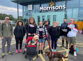 A team from Morrisons in Leamington along with dogs Archie and Chester, took part in a 28-mile charity challenge. Photo supplied