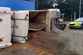 A lorry driver has been rescued by firefighters after their truck overturned at a busy junction on the edge of Lutterworth this morning (Wednesday).