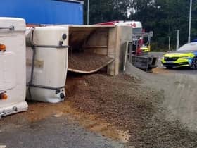 A lorry driver has been rescued by firefighters after their truck overturned at a busy junction on the edge of Lutterworth this morning (Wednesday).