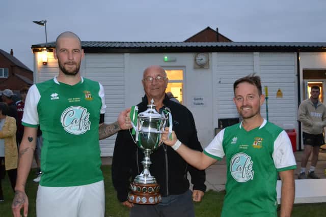 Keith Billington, Maurice's son presenting the cup to Leamington Hibs' Carl Smedley and Ashley Kitchen