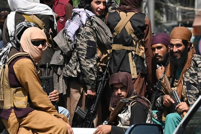 Taliban fighters patrol in a vehicle along a street in Kabul on September 2, 2021. (Photo by Aamir QURESHI / AFP) (Photo by AAMIR QURESHI/AFP via Getty Images)