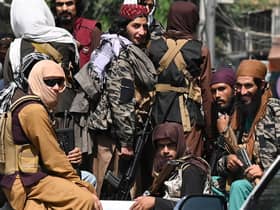 Taliban fighters patrol in a vehicle along a street in Kabul on September 2, 2021. (Photo by Aamir QURESHI / AFP) (Photo by AAMIR QURESHI/AFP via Getty Images)