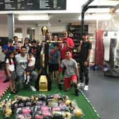Spabar CEO Jazz Gill with Leamington Community Boxing head coach Babs Kandola, the donated equipment, and the members of one of the club's youth classes.
