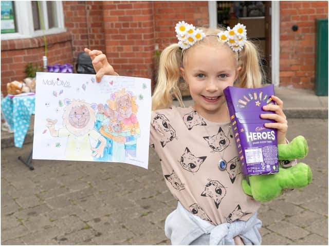 Rosie, 9, with her Olly The Brave colouring in for Molly Olly's Wishes stall. Photo by Victoria Jane Photography