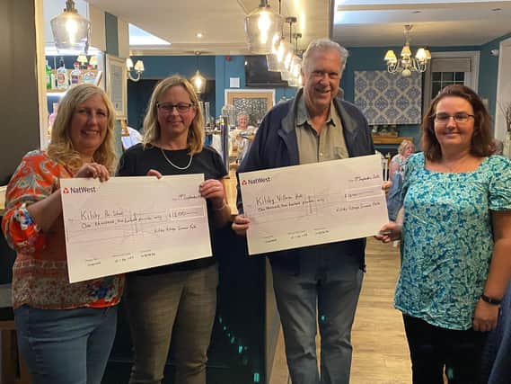 Fete committee members present two of the cheques to Kilsby School and Kilsby Village Hall.