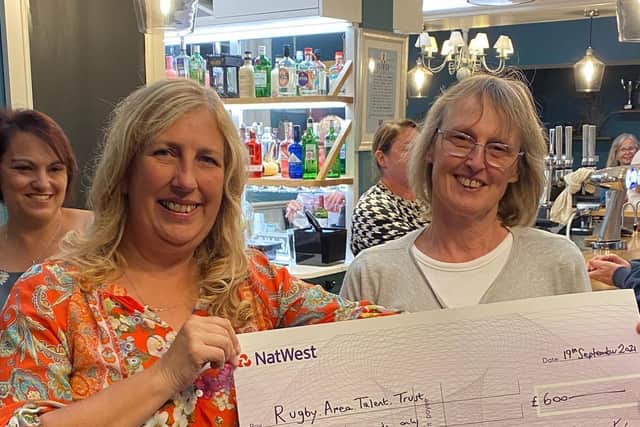 Fete committee member Andrea Brown presenting £600 to Angela from Rugby Area Talent Trust.