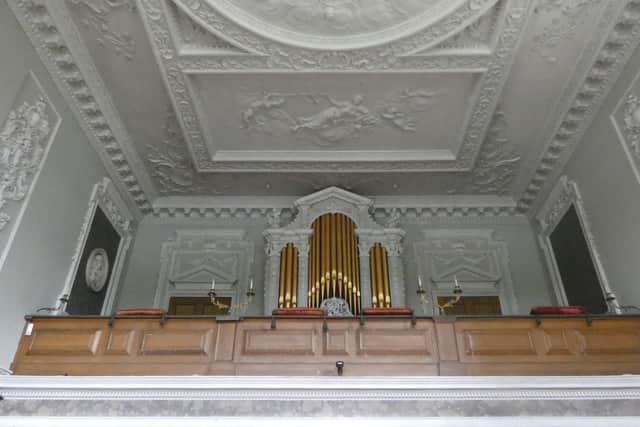 The family balcony in the Stoneleigh Abbey chapel. The crimson cushions that inspired Jane Austen can be seen resting on the balcony ledge.