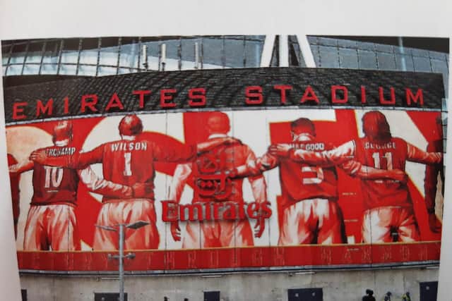 A mural showing Arsenal legends at the club's Emirates Stadium includes Eddie Hapgood wearing the number 3 shirt.