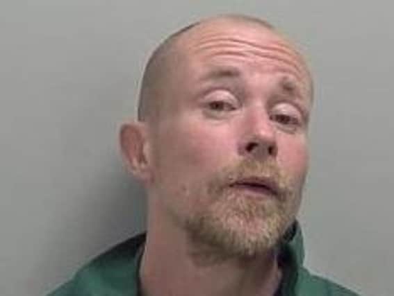 Lee Spittle, 46, is wanted by police after failing to comply with the conditions of his licence.