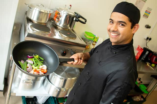 Chef Vini Campelo practices cooking one of the dishes at Brasilia To Go in Leamington.