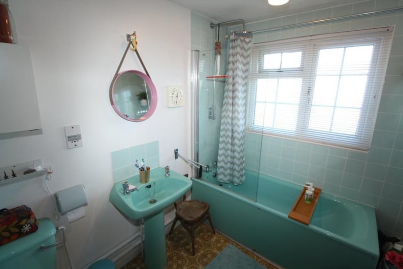 Delightful vintage turquoise bathroom.