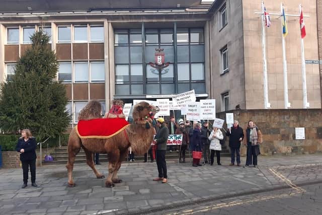 The protestors with Baxter the camel outside Shire Hall, the headquarters of Warwickshire County Council, in Warwick in January.