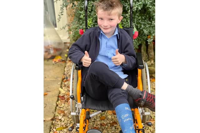 Seven-year-old Bob Carroll has already raised more than £170 by charging his friends and family to sign his plaster cast after breaking his ankle whilst trampolining. Photo supplied