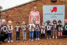 Anna Biddlestone, Nursery Manager with Sam Naylor (left) and Liz Quinn (right), both room leaders with just some of the happy Little Grange children.