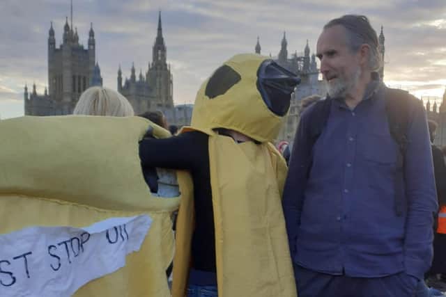Juliet Carter in her canary costume, talking to environmental activist Roger Hallam