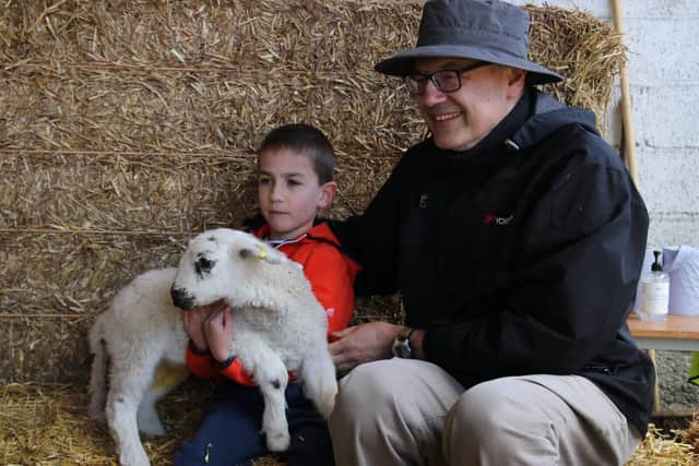 Alex (6) and dad Paris holding a lamb