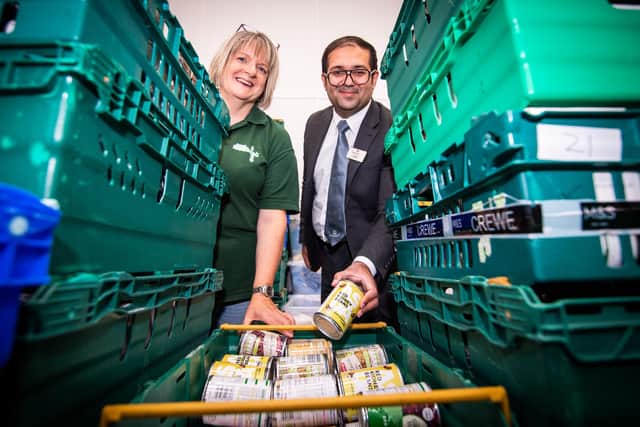 Barratt Homes’ Sales Adviser, Hassan Ali – based at the nearby Aston Grange development in Upper Lighthorne – visited Warwick District Foodbank to learn how the donation will make a difference to the charity.  Photo shows Hassan Ali with Miriam Bowen at Warwick District Foodbank. Photo by Mike Sewell