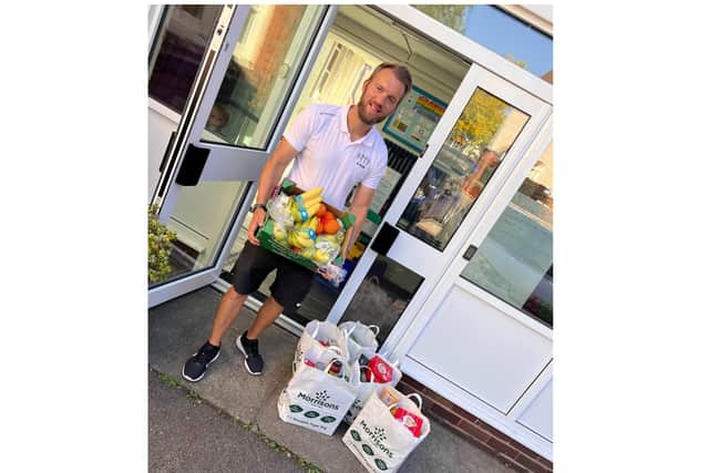 Simon Arnold from Fit 4 Kids accepting food and fruit for the children at the holiday club at Westgate Primary School. Photo supplied