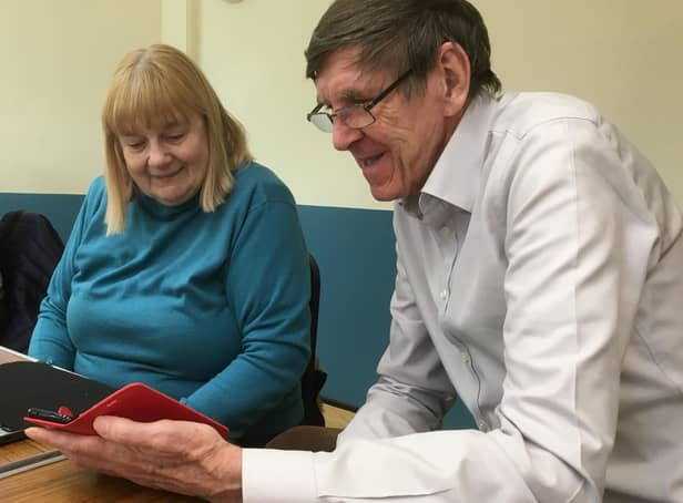 Computer Café volunteer John Morgan helps Janina Stanway with I.T. Photo supplied