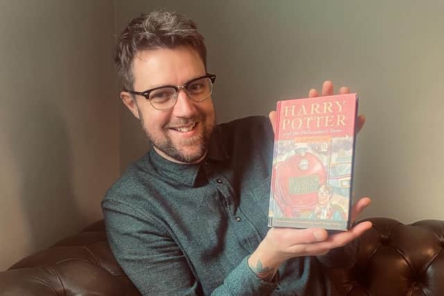 Harry Potter books expert Jim Spencer with the first edition. Photo by Rare Book Auctions