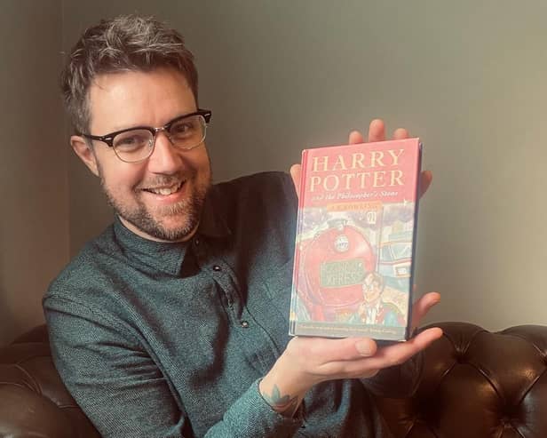 Harry Potter books expert Jim Spencer with the first edition. Photo by Rare Book Auctions