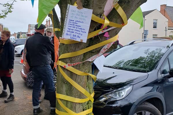 The hornbeam tree with yellow ribbons around it. Harry Potter star David Bradley is pictured in the background. Picture supplied.