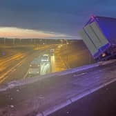 The lorry perched on the side of the motorway.