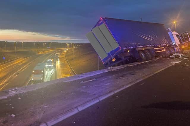 The lorry perched on the side of the motorway.