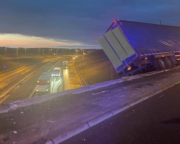 The lorry perched on the side of the motorway.