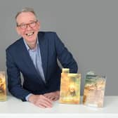 Dr Justin Newland with his novels. Photo by Christopher Alan.