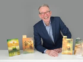 Dr Justin Newland with his novels. Photo by Christopher Alan.