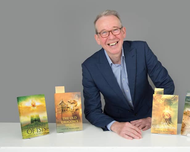 Dr Justin Newland with his novels. Photo by Christopher Alan.