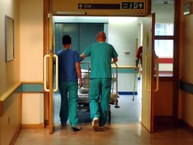 Orderlies push a bed at the Royal Orthopaedic Hospital, Oswestry.
