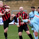 Rugby Town's Chris Clements clears the danger in the heavy defeat to Spalding United (Picture: Martin Pulley)