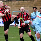 Rugby Town's Chris Clements clears the danger in the heavy defeat to Spalding United (Picture: Martin Pulley)