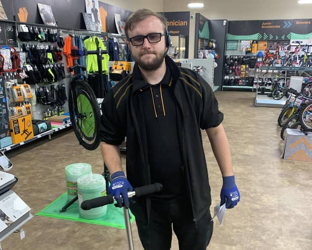 Adam Tisor, of Halfords, with the scooter.