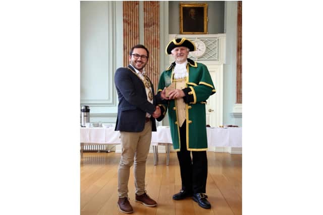 Mayor of Warwick, Councillor Richard Edgington presenting the winner of the Town criers competition Adrian Holmes with his trophy. Photo by Tirtha Lawarti