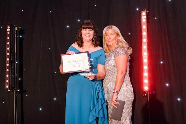 Nicky Ross collects the Against All Odds Award on behalf of Kelly Isles of Enchanted Tea Room presented by Fiona Moon. Photo by Vicki Head Photography