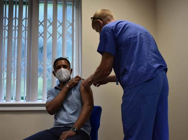 Dr Norman Byrd gives the millionth jab at the vaccination centre in Rugby.