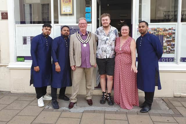 Cllr Simon Button, the Mayor of Whitnash, and guests with staff at the Millennium Balti