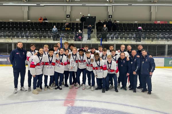 Rhodes Mitchell-King holds the silver trophy along with his Great Britain team-mates