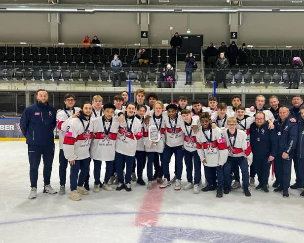 Rhodes Mitchell-King holds the silver trophy along with his Great Britain team-mates
