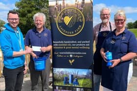 Aaron Coleman from Parkinson’s UK accepts the cheque from Ian Jamie, John Nichols and Lydia Haley from Warwickshire Lavender Farm