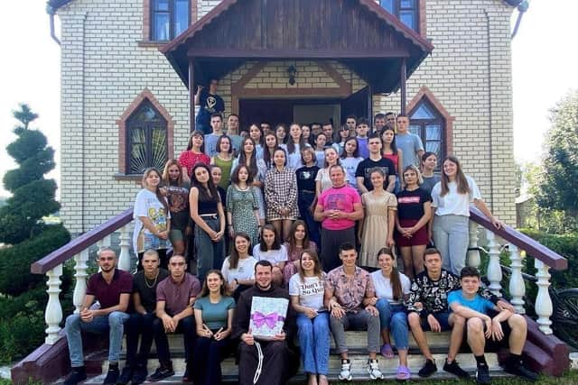 Everyone gathers together outside the church in Shepitivka with a thank you gift for Father Tomas. Picture submitted.