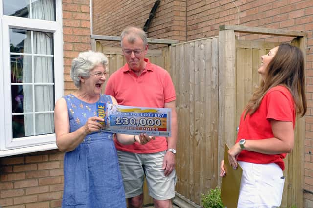 Sarah Vincett and Christopher Vincett with lottery ambassador Judie McCourt. Photo supplied by The Postcode Lottery