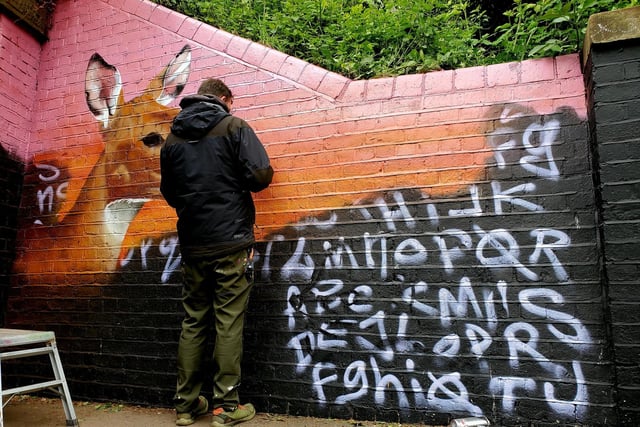 Work taking place on part of the mural.