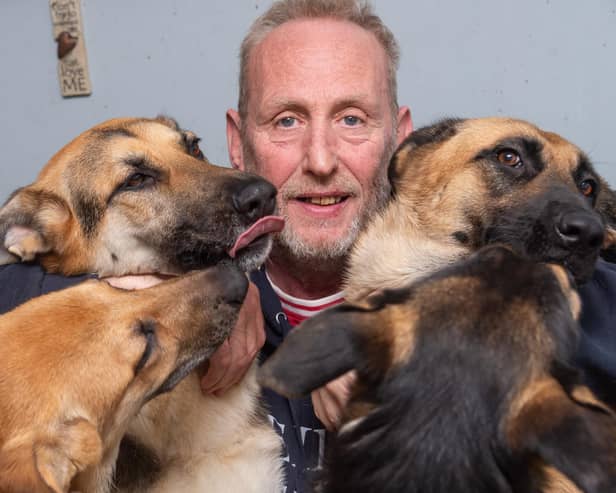 Steve Clarke with some of the eight German Shepherd dogs he owns. Picture by Mike Baker.