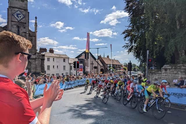 The crowd at East Gate in Warwick cheers the cyclists on.
