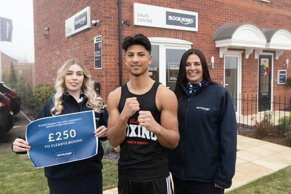 Left to right:  Aman Kumar from Cleary’s Boxing  (centre) was pleased to accept the donation from Bloor Homes sales staff Hope (left) and Zoe (right). The donation will be for Health and Safety compliance, enabling the boxing gym to support challenged young people and give them a positive experience through sport.